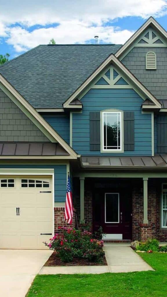 Beautiful modern house with blue siding and gray roof, showcasing construction quality.